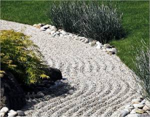 A decorative path around a flower bed accents attention and serves as a beautiful decoration for landscape design.
