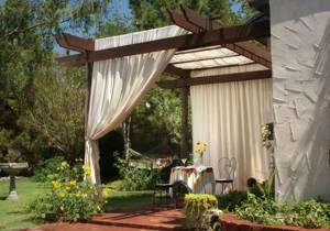Wooden canopy with light fabric curtains