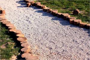 Path made of crushed stone and fenced with wooden posts