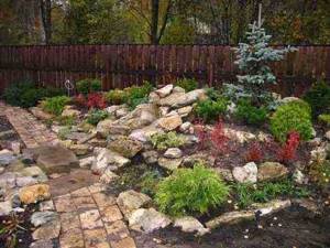 Raised flower beds, rockeries and slides will help visually expand the space