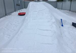 construction of a snow slide in the yard. forming a descent 