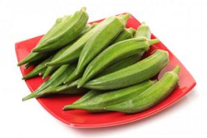 okra pods on a red plate
