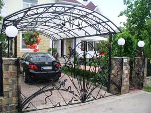 Installing a beautiful wrought iron carport in front of the house