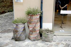 Flowerpots and flower stands made from colored concrete mixtures are used not only for their intended purpose, but also as a very attractive, decorative element
