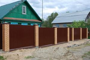Corrugated fences with brick pillars